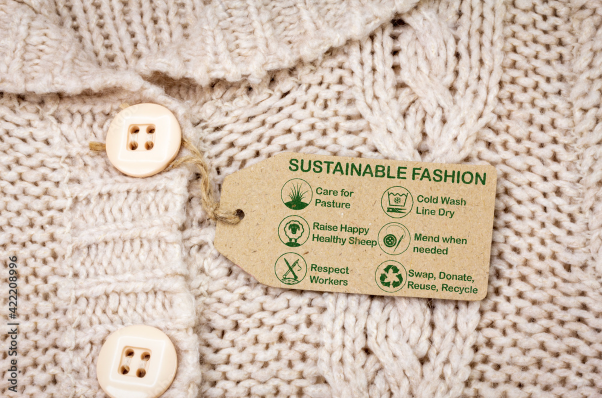 Closeup image of a sweater with a tag that says Sustainable Fashion